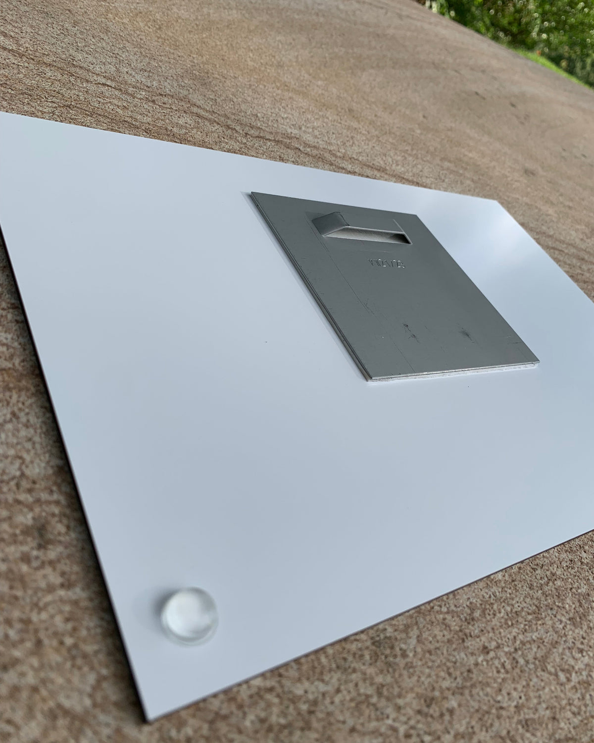Arrière du support en aluminium dibond. L accroche est en métal pour faciliter une accroche au mur, les points en plastiques permettent de ne pas abîmer vos murs.